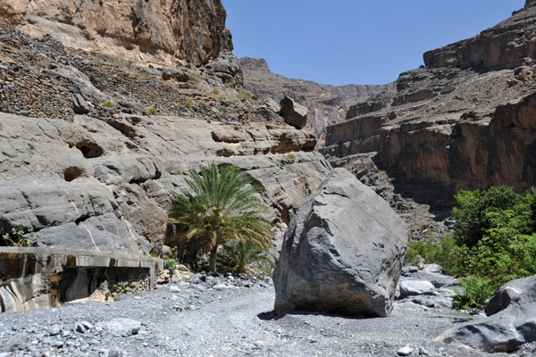 Wadi An Nakhur with steep cliffs both sides