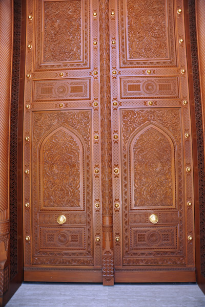 Massive carved wooden doors to the main prayer hall