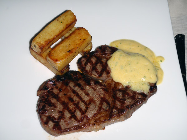Nice steak with 4 french fries, artfully arranged