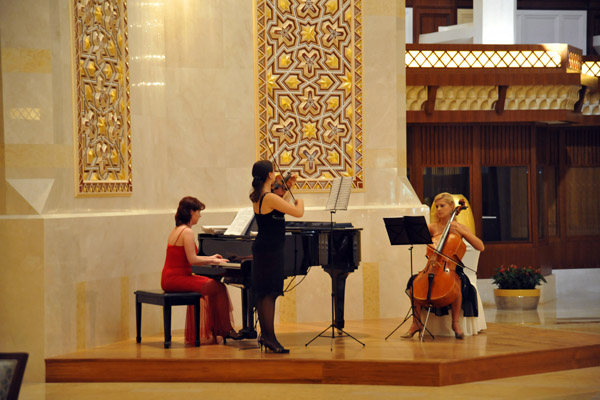 Classical trio playing during tea time at the Al Bustan Palace Hotel