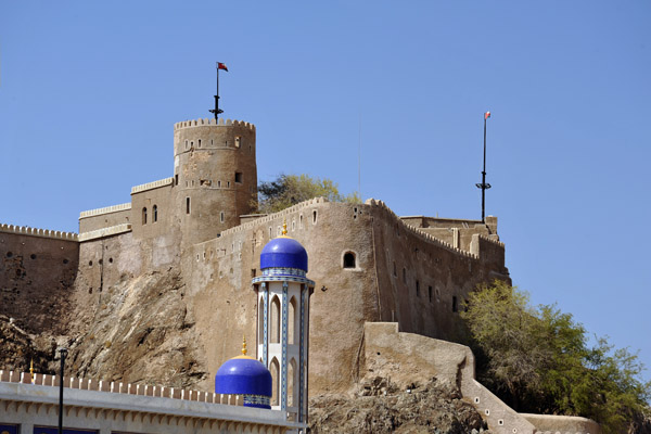 Mirani Fort with the blue domed minaret of Al Khawr Mosque, Muscat