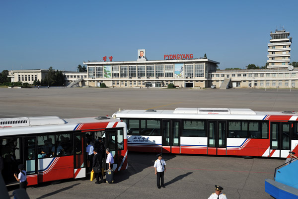 Boarding busses for the short ride across the ramp at Pyongyang