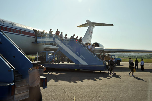 Deplaning by stairs on a warm summer day in Pyongyang