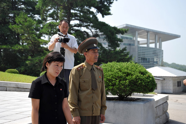 North Korean officer and the English translater being filmed by our group's cameraman