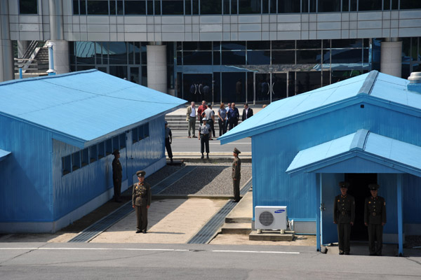 The border between North and South Korea runs through the middle of each of the blue huts