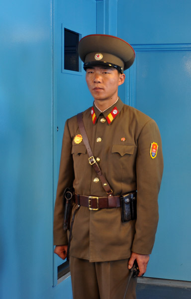 DPRK soldier on the ROK side of the hut guarding the southern door
