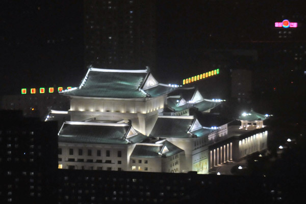 Pyongyang Grand Theatre illuminated at night, from Yanggakdo Hotel