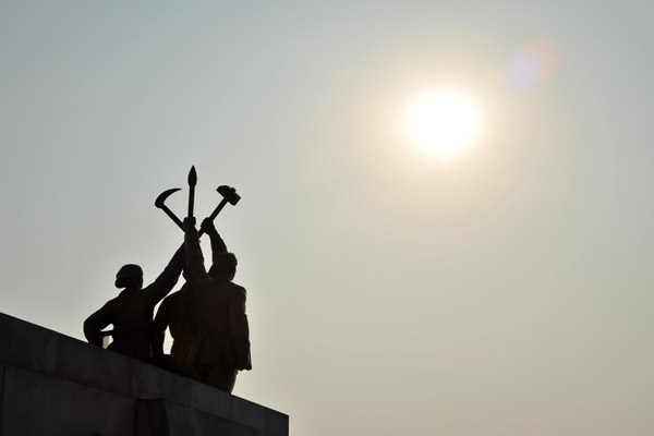Statue at the base of Juche Tower - farmer, worker, intellectual