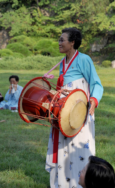 Old North Korean woman with a drum, Moranbong Park
