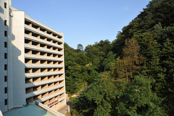 Rear wing of the Hyangsan Hotel nestled against the forested hillside