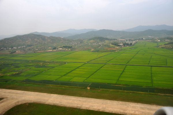 The rice paddies and hills near Pyongyang Sunan Airport, North Korea