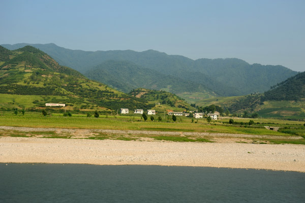 Green hills beyond the sandy banks of the Chongchon River, North Korea