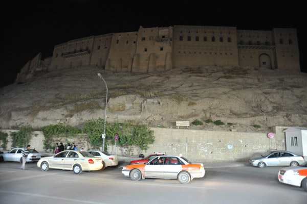 Taxis driving along the ring road around the Erbil Citadel at night
