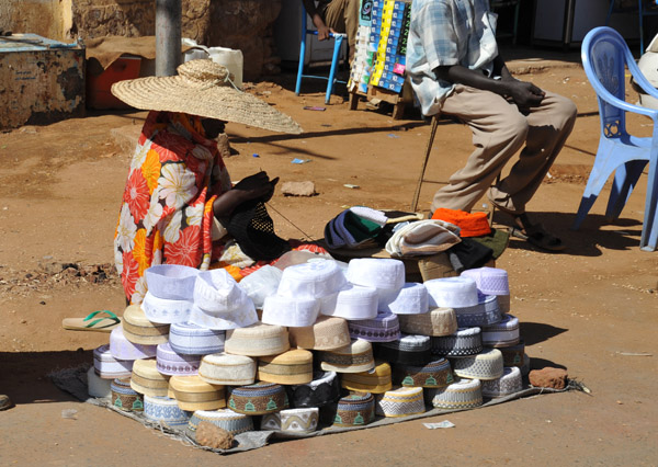 Woman selling caps on the street, Omdurman