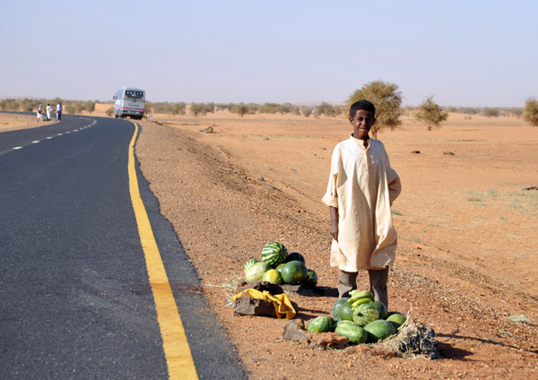 Sudanese villager selling watermelons along the road