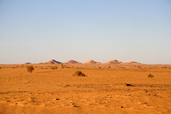 Six small hills rising out of an otherwise flat desert