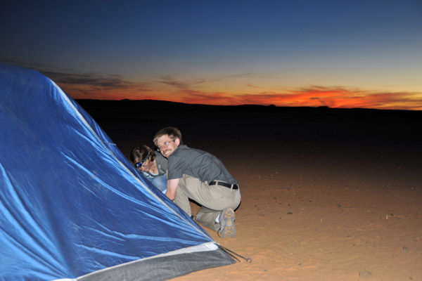 Trygve and Karen setting up their tent as dusk falls