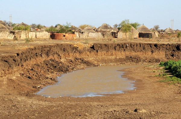 Water hole next to a village