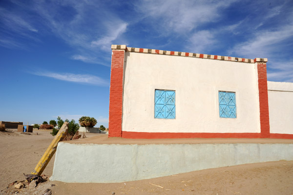 Tidy Nubian house with stripes painted along the roofline