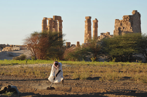 Nubian farmer at work next to the Temple of Soleb