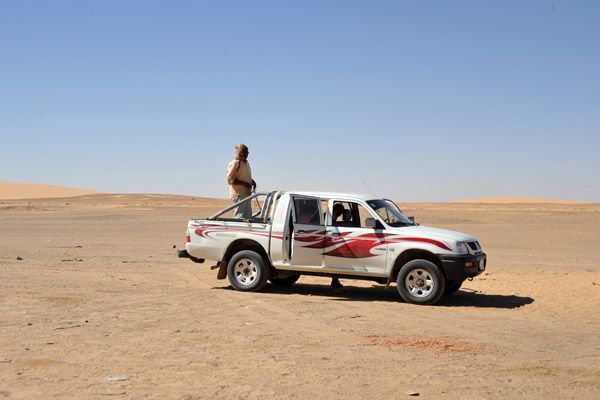Mahmoud surveying the desert from the back of the truck