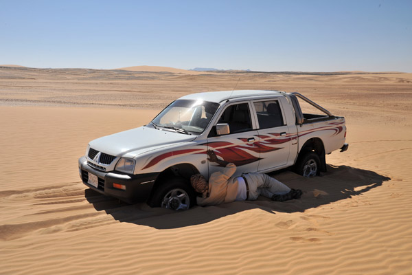 Mahmoud attempting to dig out the car