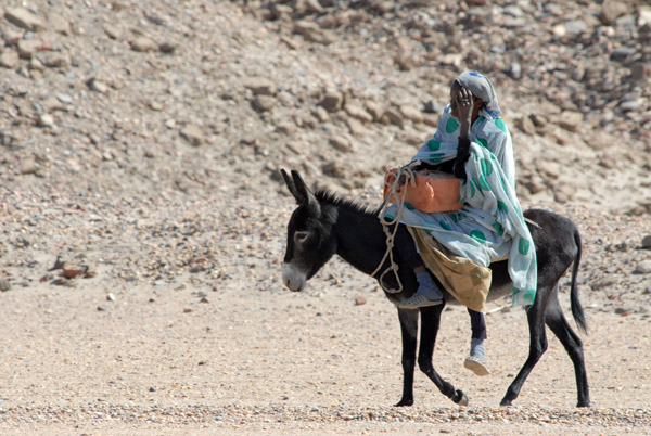 Woman riding a donkey, Sai Island