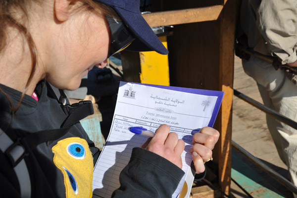 Karen filling out a Tourist Information Form issued by the government of Al-Shamaliya State (North Sudan)