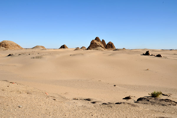 Ruins of the ancient pyramids at Nuri rising out of a sandy desert