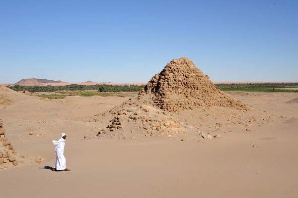 Sudanese man walking among the Pyramids of Nuri