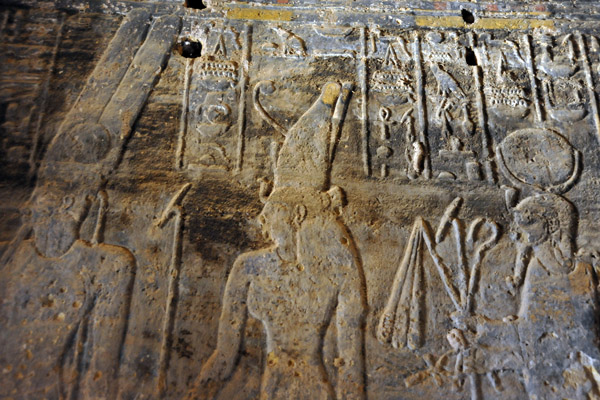 Carvings of Egyptian gods in the Temple of Mut - Amun on the left, Mut in the center, Hathor on the right