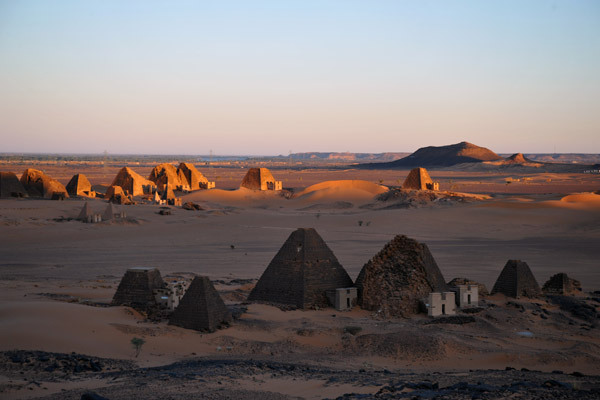 The morning light illuminating the northern pyramids while the hill keeps the southern pyramids in shadow