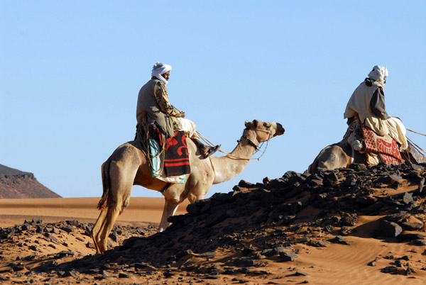 Sudanese men looking to offer tourists camel rides, Mero