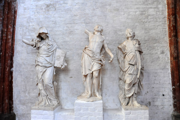 Damaged sculptures displayed in the ambulatory behind the main altar