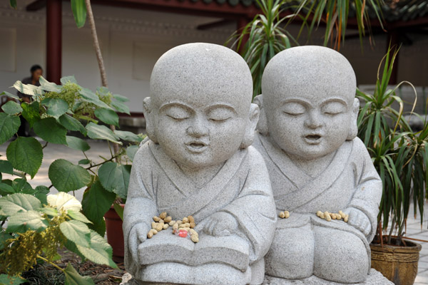 Stone statues of little monks at Guangxiao Temple
