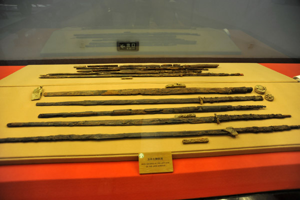 The rusting remains of iron swords found on the side of the king's body