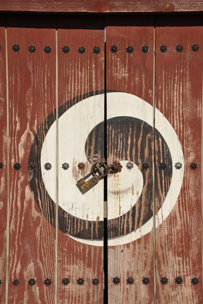 Black and white yin-yang on a red door