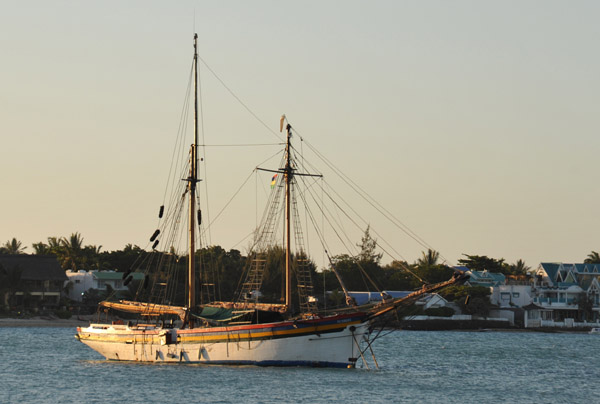 Two-masted sailing ship painted with the colors of the flag of Mauritius