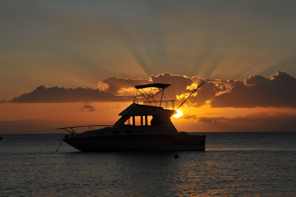 Sunset with the silhouette of a fishing boat, Mauritius-Balaclava