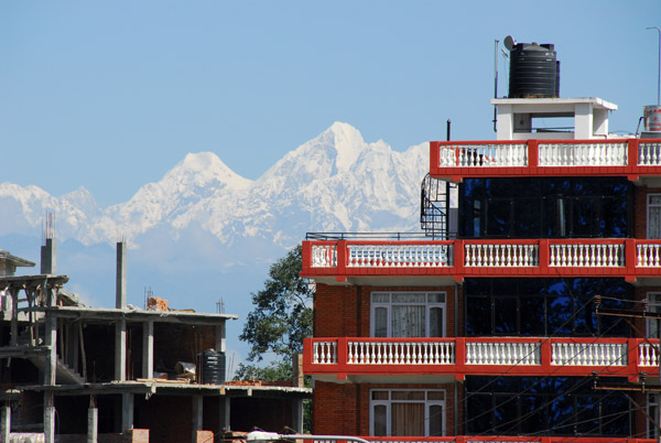 Himalayan peaks behind some new buildings in Dhulikhel