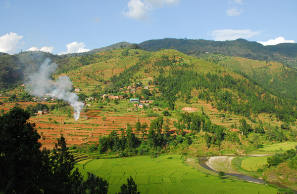 Hillside village with a burning field, Nepal