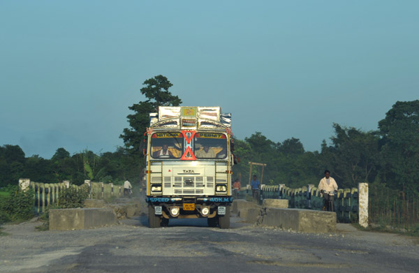 Oncoming traffic crossing a horribly maintained one-lane bridge, West Bengal
