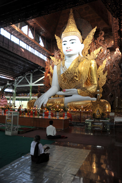 Worshipers sitting in front of the Buddha image