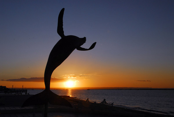 Breaching whale sculture at sunset, La Paz