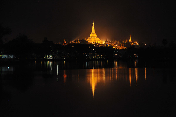 The golden stupa of Shwedagon Pagoda reflected in Kandawgyi Lake, Yangon