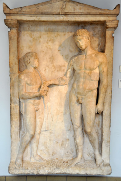 Tombstone from Delos with nude youth taking oil flask from a boy attendant ca 375 BC