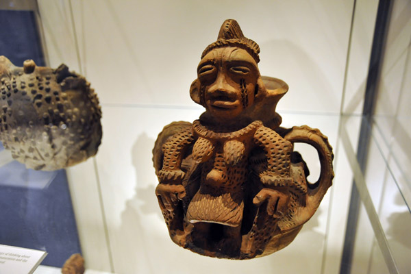 Heavily ornamented pot in the form of a pregnant female, Edo people, Benin, Nigeria, 20th C.