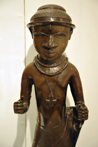 Cast brass figure wearing a cross, Benin, Nigeria, 16th C.
