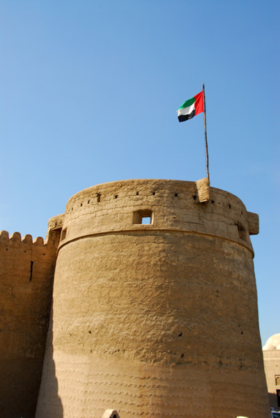 Tower of Al Fahidi Fort flying the UAE flag