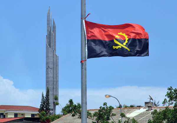 Angolan Flag with the tower of the Mausoleum of Agostinho Neto, MPLA leader then the 1st President of Angola 